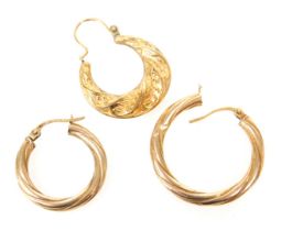 Two 9ct gold hoop earrings, and a further earring with embossed foliate decoration, 2.3g.