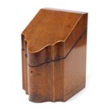 A George III mahogany and boxwood inlaid knife box, of serpentine form, the hinged lid opening to re