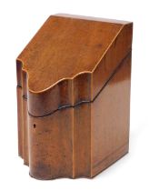 A George III mahogany and boxwood inlaid knife box, of serpentine form, the hinged lid opening to re