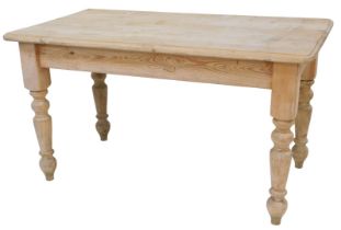 A pine kitchen table, the rectangular top with a moulded edge, on turned legs, 77cm high, the top 13