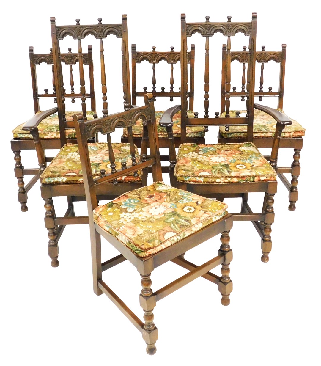 A set of six oak dining chairs in Ercol / Old Charm style, each with a carved back, solid seat wit