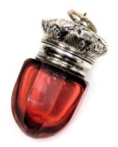 A Victorian cranberry glass vinaigrette with a hinged lid, and pierced grill, embossed with leaves a