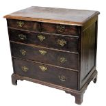 An 18thC oak chest of drawers, the rectangular top with a moulded edge above two short and three lon