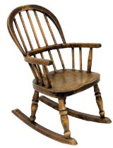 A late 19th/early 20thC ash and elm child's Windsor rocking chair, with spindle turned back, solid s