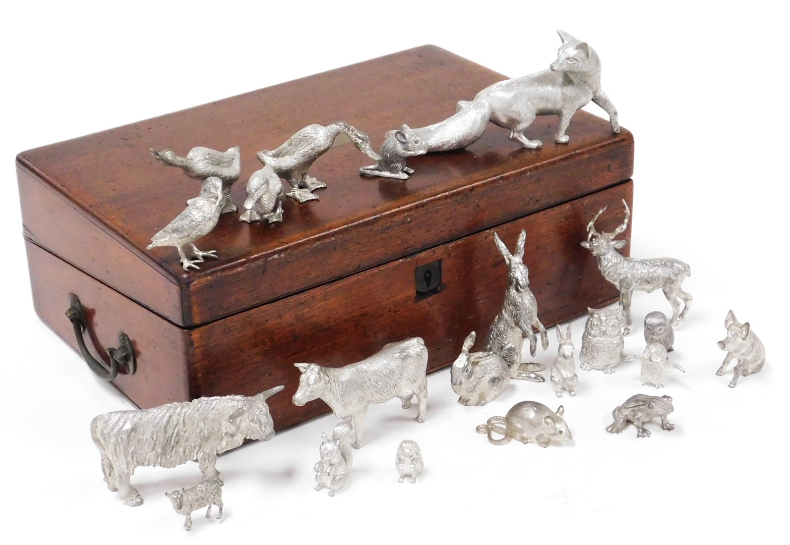 A group of silver plated figures, of animals, birds and a frog, including fox, hare, cow, stage, owl