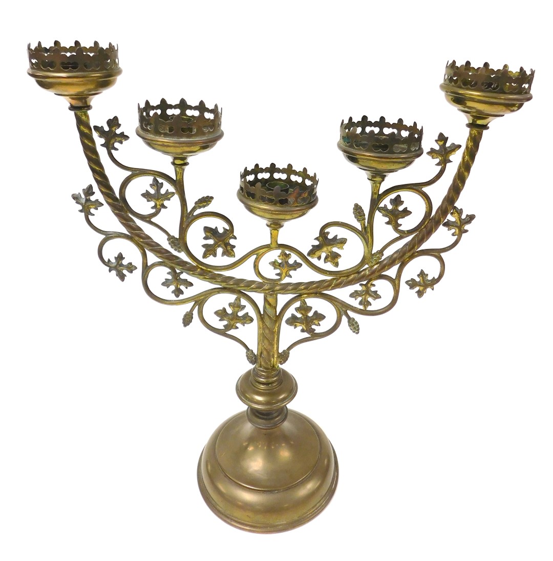 A Victorian Gothic brass altar candelabrum, of five branch form, with scrolling vines, raised on a c