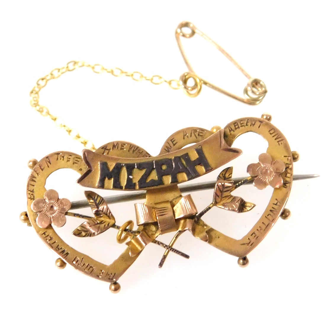 A 9ct gold Mizpah brooch, with a scrolling titled banner fronting a pair of conjoined hearts, and fl