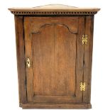 An early 19thC mahogany cabinet, singled panelled door, 92cm high, 73cm wide.