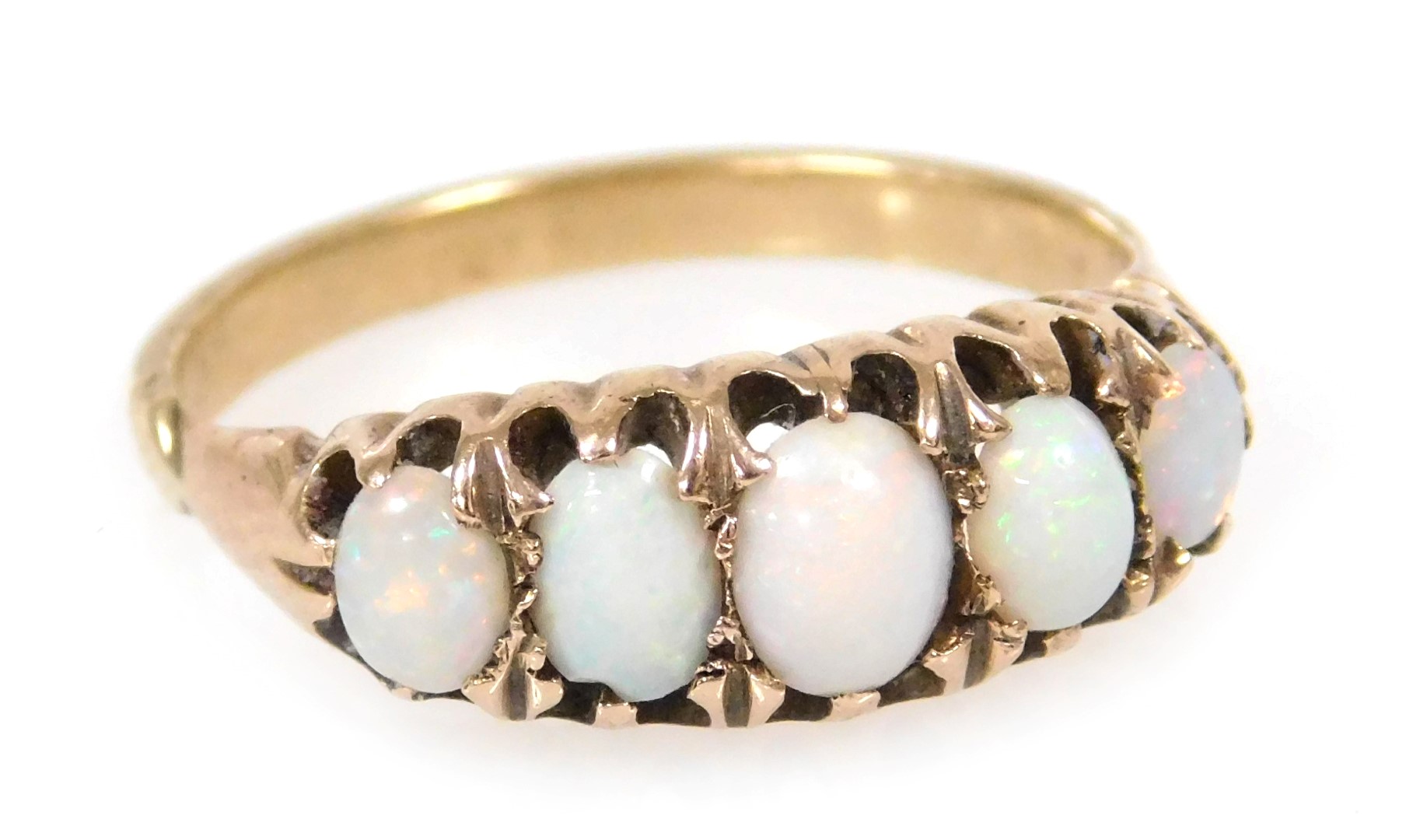 An opal five stone ring, in yellow metal, unmarked, size O, 3.0g.
