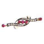 A Victorian ruby, diamond and seed pearl brooch, in a scrolling design, in white and yellow metal, 4