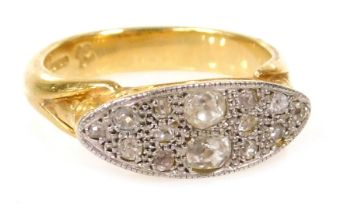An 18ct gold and diamond cluster ring, in a channeled oblong design, high scroll set, approx 0.5ct