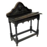 A stained oak and carved hall table, with galleried back, raised on turned supports joined by a stre