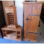 A pine wine storage cabinet, with single door to top and wine rack below, raised on bracket supports