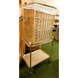A wicker linen basket, with liner, and a two tier tea trolley with castors to base.