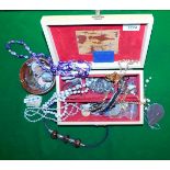 A jewellery box containing a quantity of necklaces, bangles, beads, rings, etc.