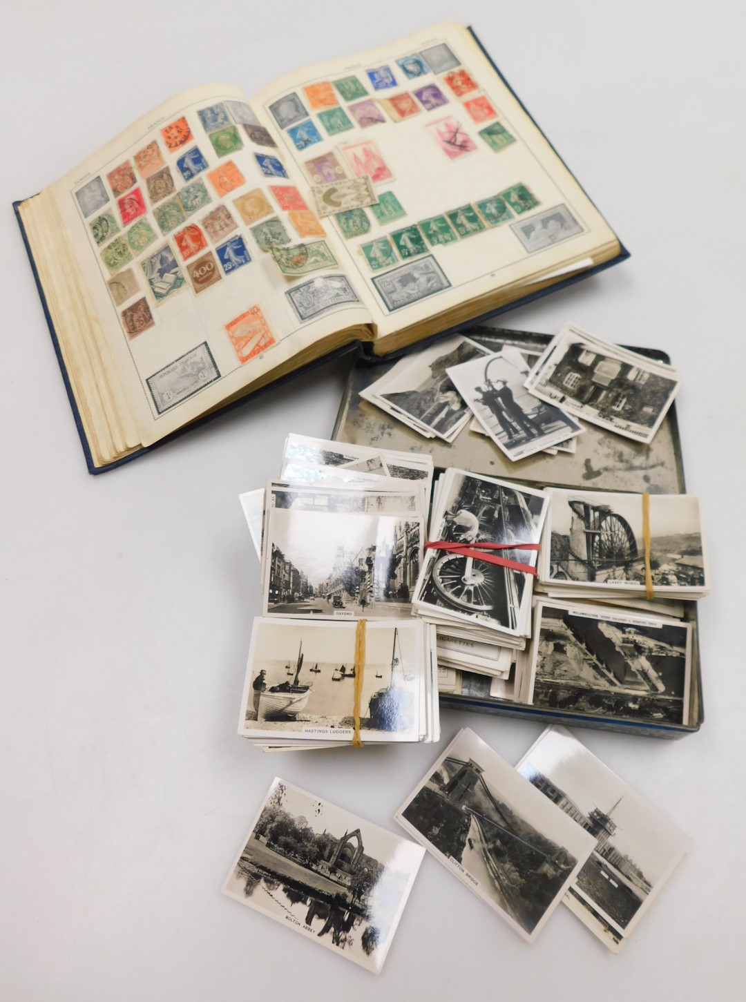 A Victory stamp album, selection of cigarette cards, including Senior Service in a tin.