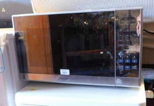 A modern microwave oven, model number K25MSS19.