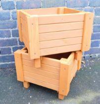 Two square hand built modern planters, wooden, stained brown, 33cm high, ;8cm, wide, 38cm deep.