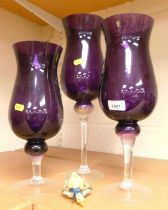 Three tall tulip shaped glasses, purple bodies, clear stems, the tallest 64cm high.