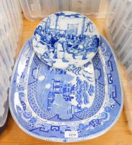 A 19thC blue and white Willow pattern meat platter, and a Delft blue and white plate decorated with