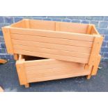 Two modern hand built rectangular wooden planters, stained brown, 35cm high, 55cm wide, 37 deep.