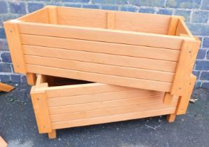 Two modern hand built rectangular wooden planters, stained brown, 35cm high, 55cm wide, 37 deep.