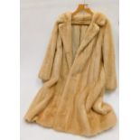 A lady's full length imitation fur coat.