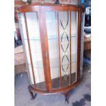 An early 20thC display cabinet, with glazed panelled door, raised on short cabriole supports of demi