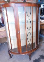 An early 20thC display cabinet, with glazed panelled door, raised on short cabriole supports of demi