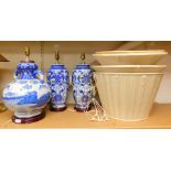 Three ceramic lamps, decorated in the Oriental manner in blue and white with three shades, the talle