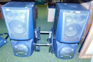 A pair of large Sony Stero Systems, with a pair of Saw Super Woofers, on stands.