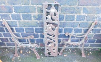 A cast metal frame with two ends and seat for a child's garden bench, cast iron.