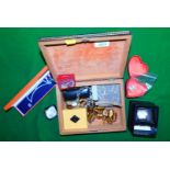 A small marquetry wooden box containing various items of costume jewellery, including a watch, neckl