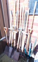 A quantity of garden tools, including spades, forks, hose, clippers, etc.