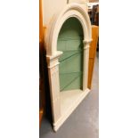 A Georgian and later corner cupboard, with arched top and reeded and fluted supports, painted in whi