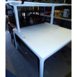 A large white office table for two people, 141cm wide, 140cm deep. and a smaller white table for one