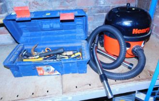 A Henry hoover and a toolbox containing various hand tools, including hammers, sockets, etc.