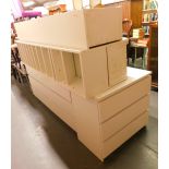 A white melamine finish chest of three long drawers, two further three drawer chests and two white m