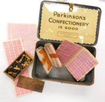 A Parkinson's Confectionary tin, containing stamp books.