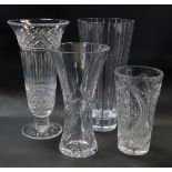 Four cut glass vases, one of waisted form, 25cm high.