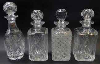 Four cut glass decanters and stoppers, three of square form, differing designs, 26cm high, and one