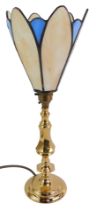 A brass table lamp, with a leaded glass shade, of petalated form, in cream and blue, 40cm high.