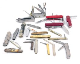 A group of penknives, Swiss type army knives, to include one for Blacksmiths Shop Gretna Green,