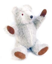 A late 20thC jointed Teddy bear, in pale grey, with brown pads, 54cm high.