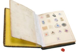 A 19thC and later album, containing painted crests from letters, the book belonging to Ellen M J