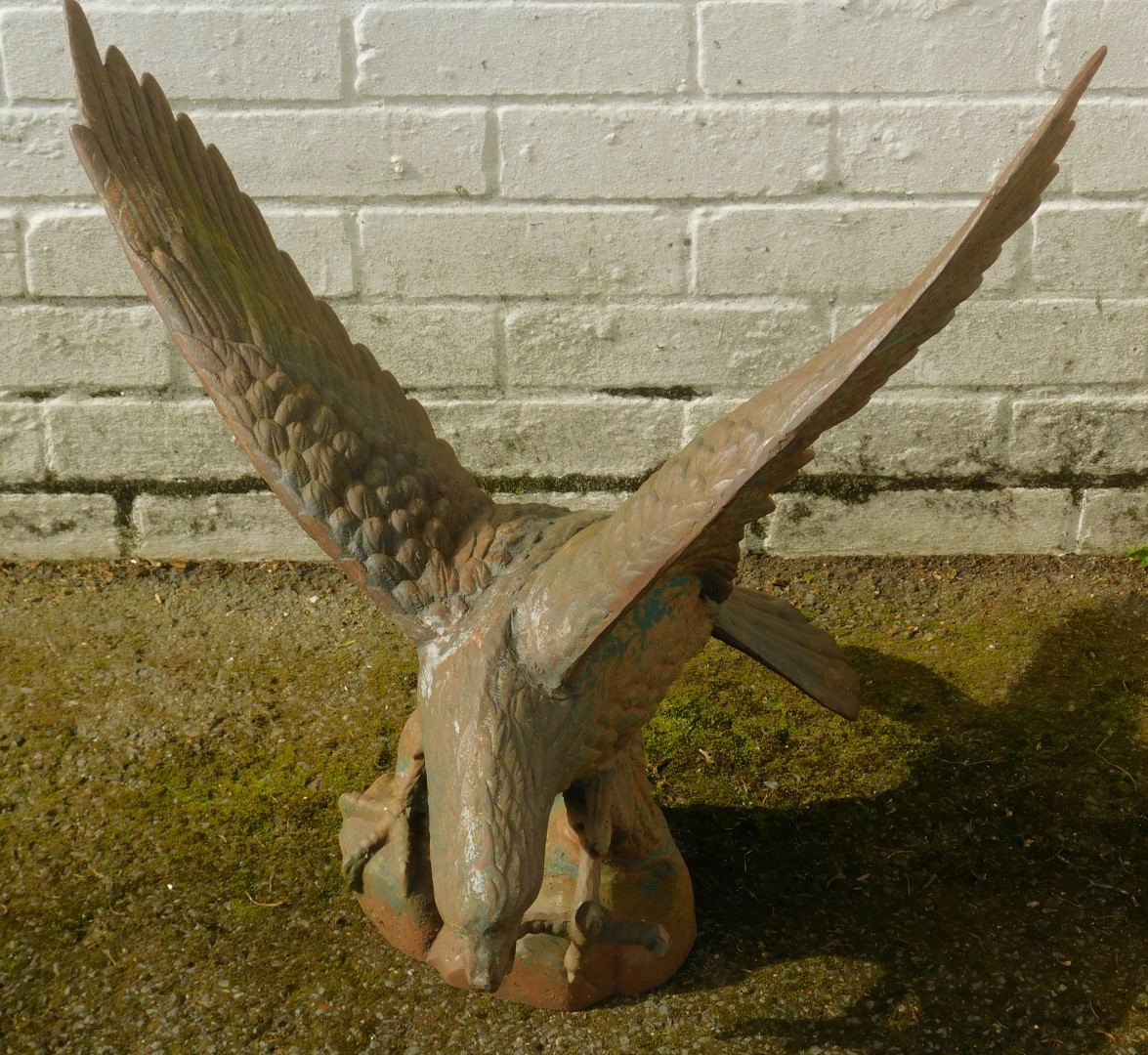 A cast metal figure modelled as an eagle, with wings outswept standing on a rocky plinth, 64cm - Image 2 of 3
