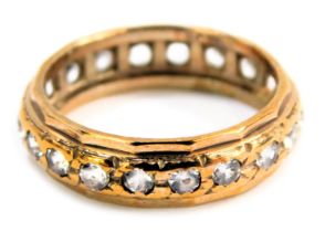 An eternity ring, set with cz stones, yellow metal stamped 9ct silver, ring size J½, 2.3g all in.