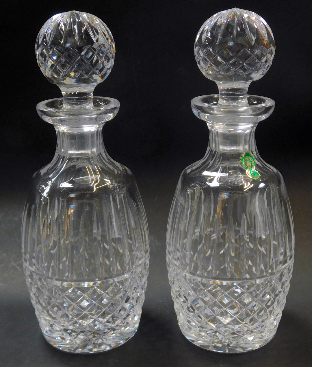 A pair of Waterford crystal Tramore pattern decanters and stoppers, one with paper label, each