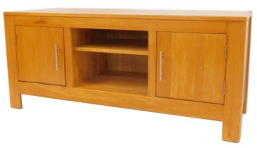 A contemporary oak television cabinet, the rectangular top above two recesses flanked by two
