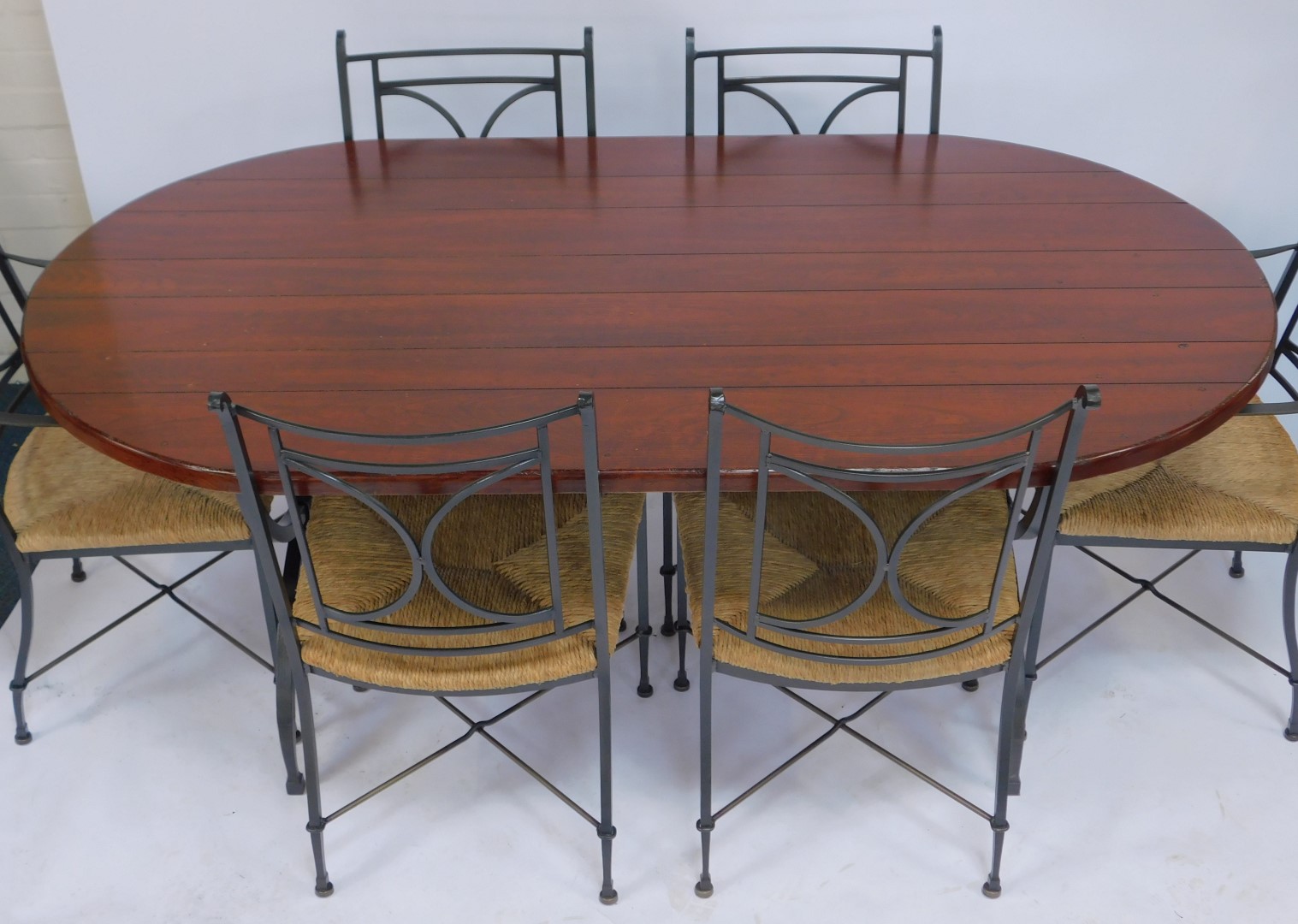 A modern hardwood oval dining table, raised on X shaped wrought iron end supports, 77cm high, the - Image 2 of 4